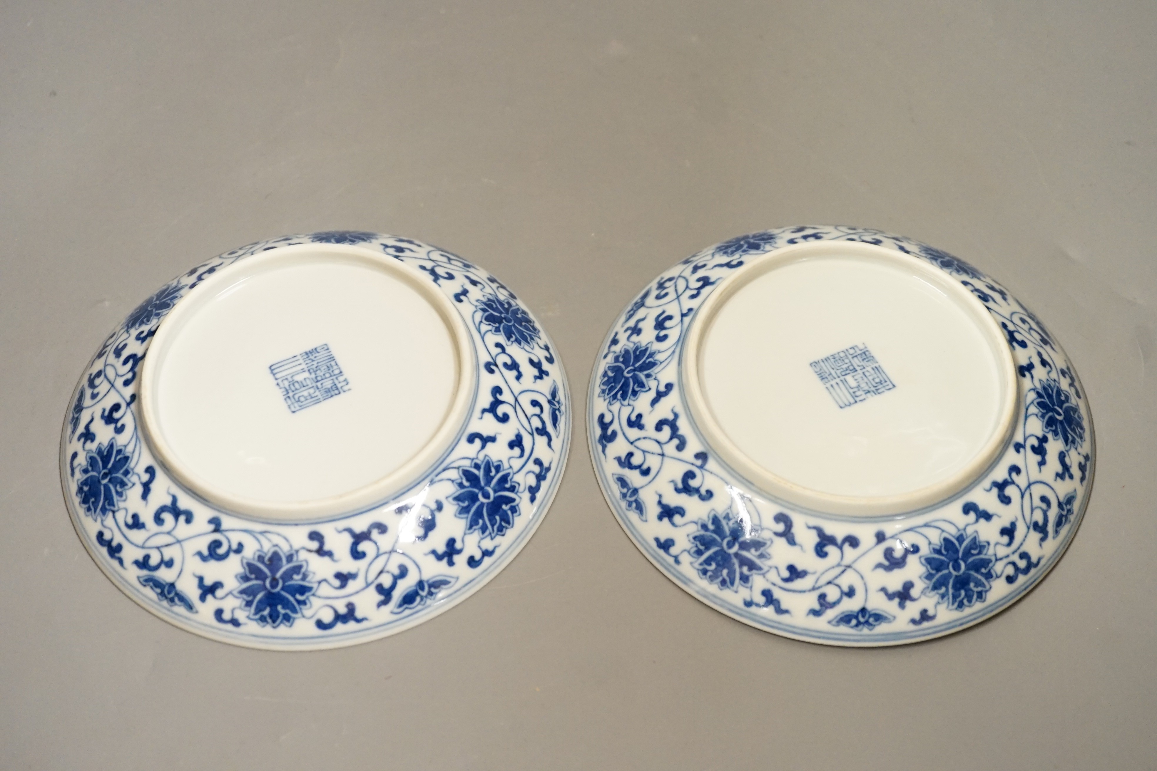 A pair of Chinese blue and 'white lotus' dishes, Qianlong marks, 16.5cms diameter